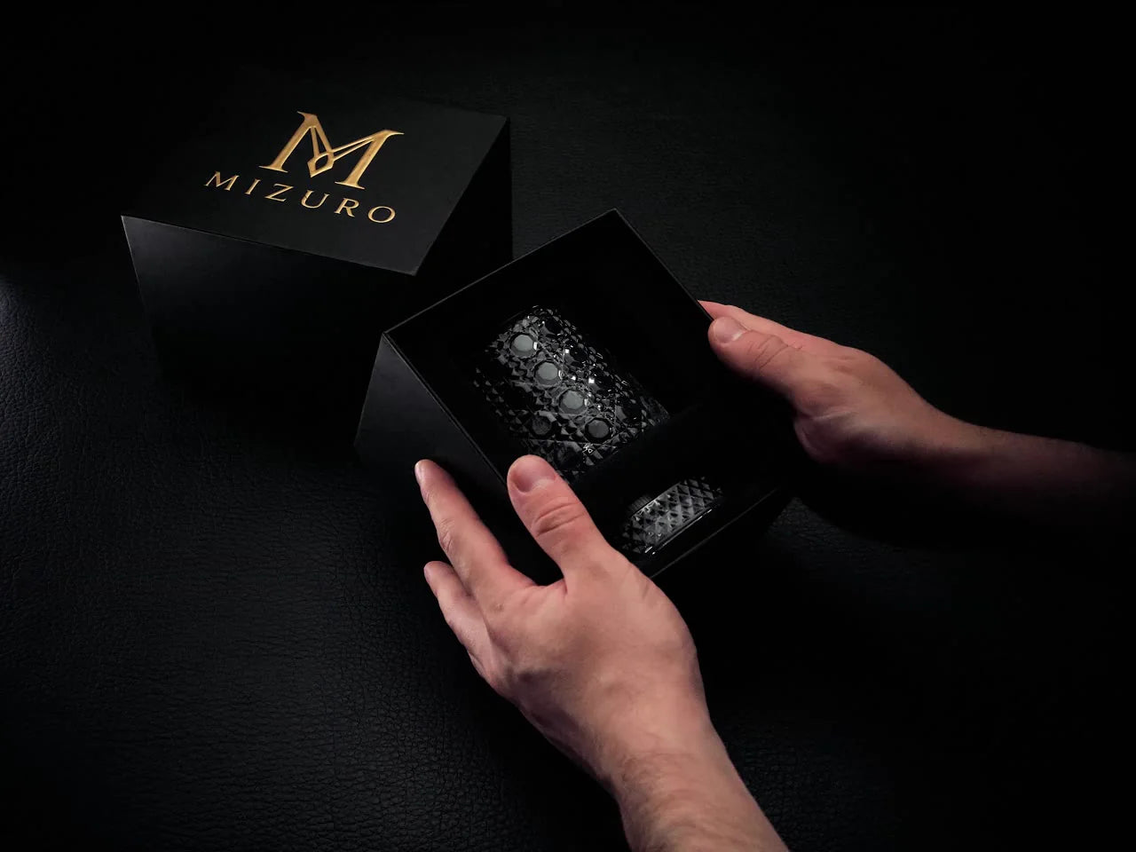 An open Mizuro box with a Kaze glass and base, held in two hands