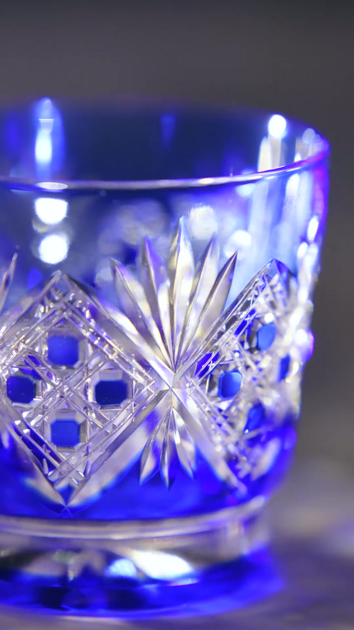 Close detail of the finished facets and blue color in the cut glass tumbler